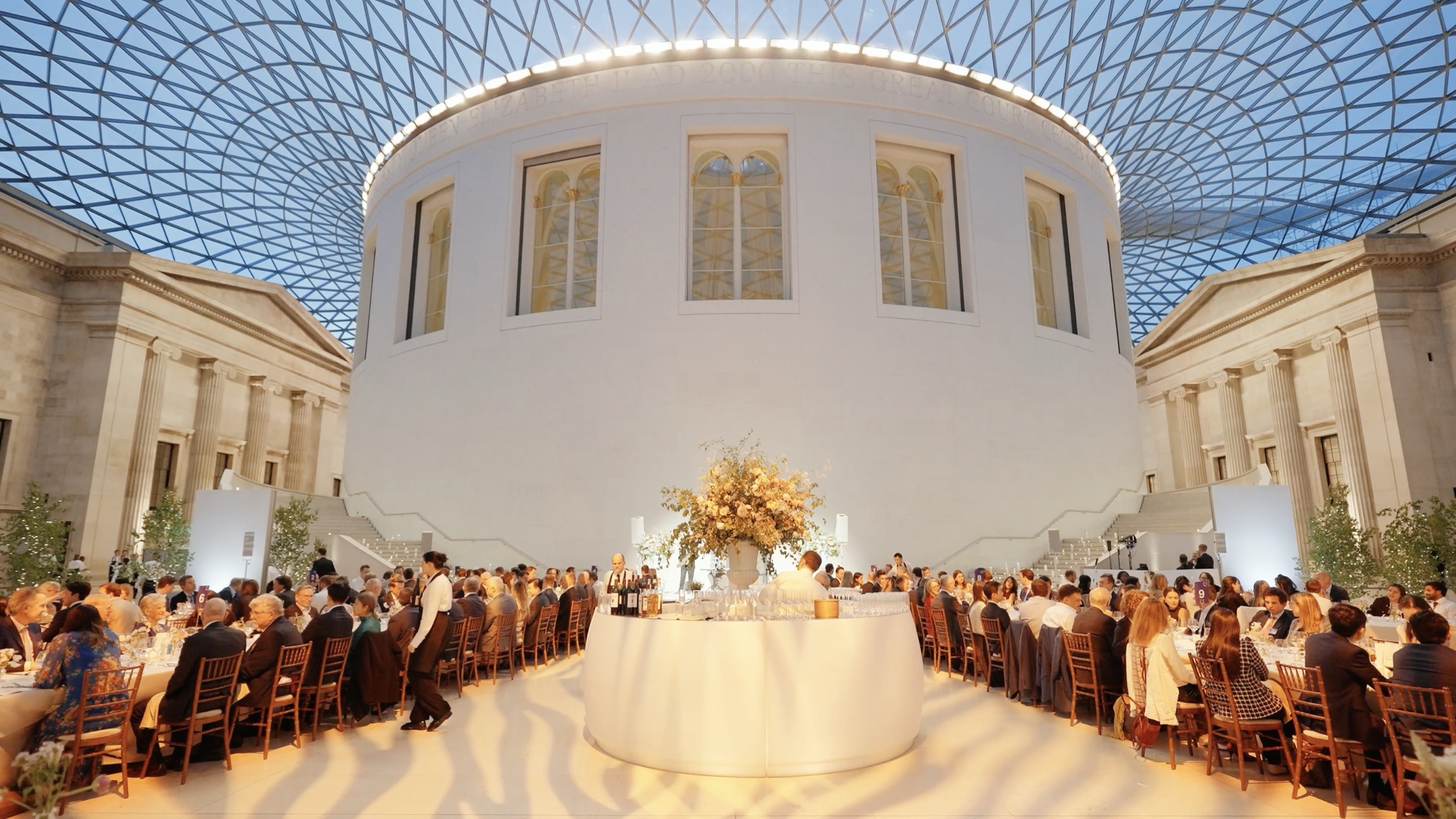 Premium gala dinner setup with elegant styling in the Great Court under the glass roof at the British Museum